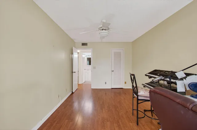 a view of a lake with a big yard and large trees