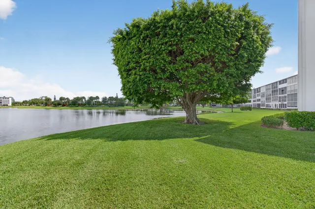 an aerial view of residential houses with outdoor space and parking