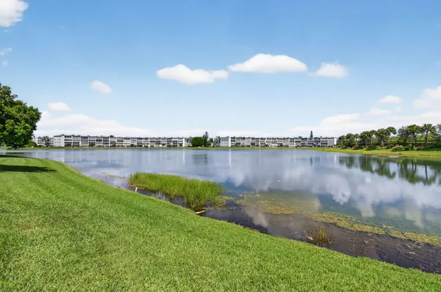 an aerial view of residential houses with outdoor space and swimming pool