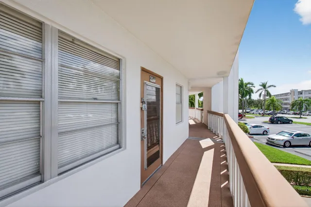 a view of a room with wooden floor windows and lounge chair