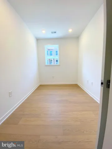 an empty room with closet and windows