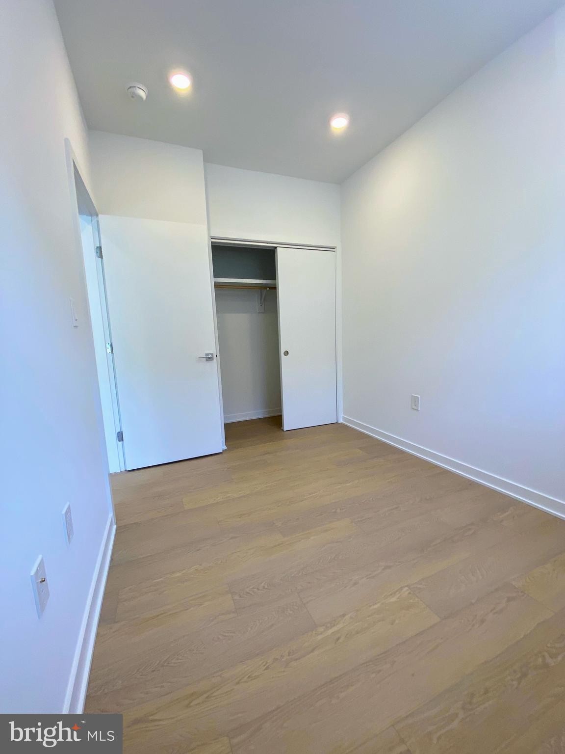3435 Brown Street Northwest, Unit 1 Washington, DC 20010 - Photo 9 of 13 an empty room with closet and windows