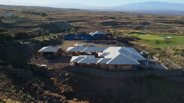 a view of a big yard with a table and a lake view