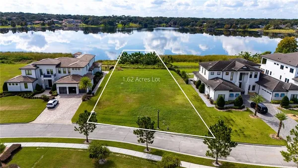 an aerial view of residential houses with outdoor space and swimming pool