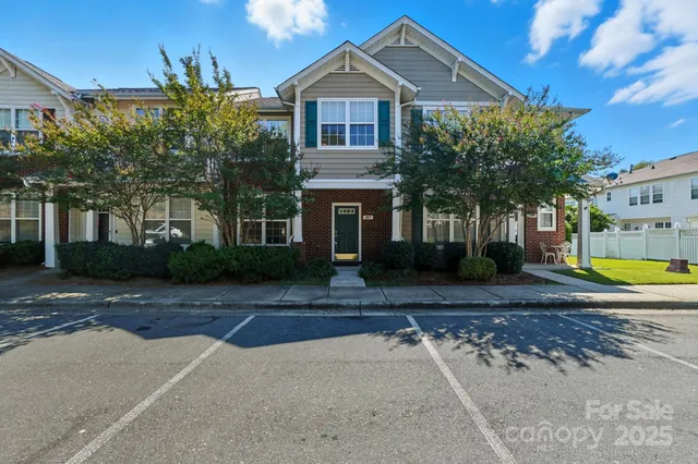 a view of house with outdoor space and tall tree