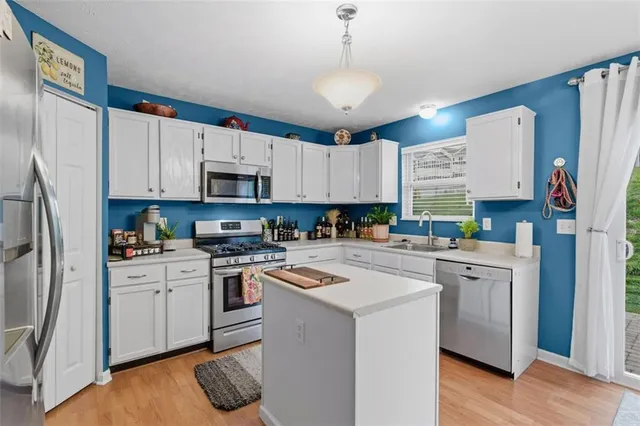 a kitchen with cabinets and stainless steel appliances