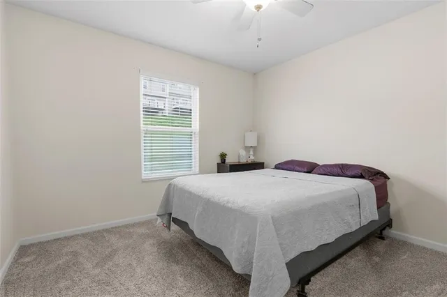 a bed sitting in a bedroom next to a window