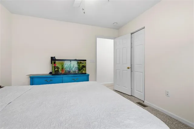 a bedroom with a bed and a mirror