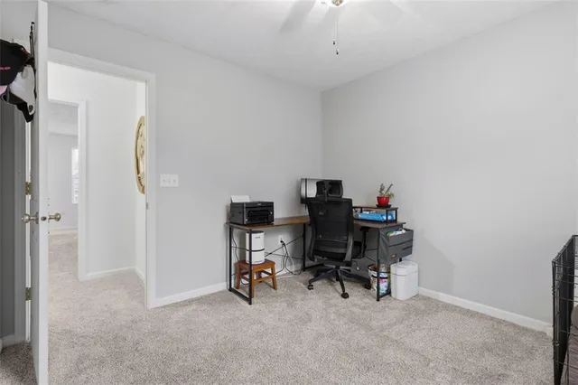 a view of a workspace with furniture and a gate
