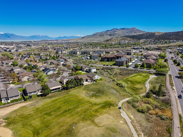 8215 Clear Rock Road, Unit 12 Eagle Mountain, UT 84005 - Photo 21 of 38 Expansive aerial perspective showcasing a residential community with a background of mountains and a body of water