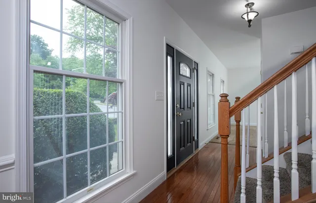a view of staircase with railing and white walls