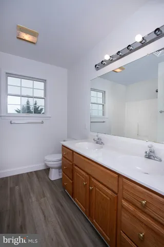 an outdoor sitting area with furniture and wooden floor