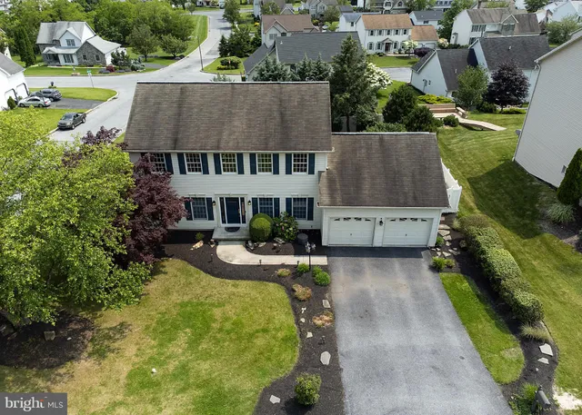 an aerial view of a house with garden space and street view