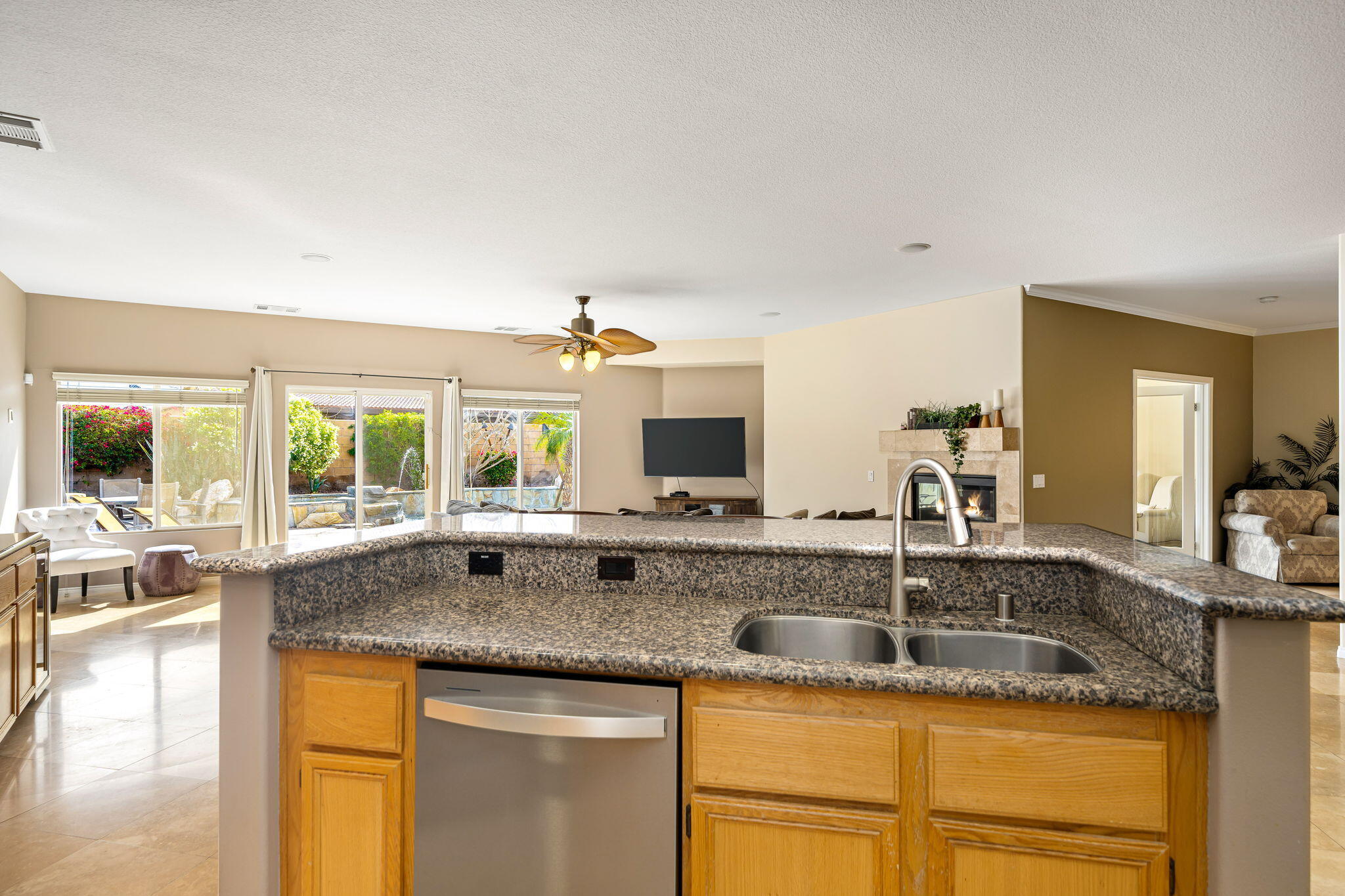 41222 Mackenzie Lane Indio, CA 92203 - Photo 13 of 27 a kitchen with granite countertop a sink and a granite counter tops