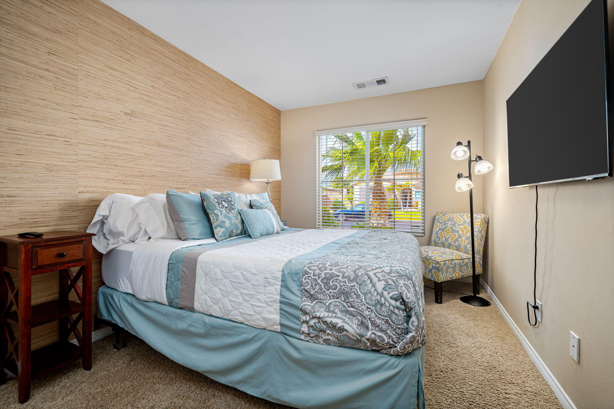 41222 Mackenzie Lane Indio, CA 92203 - Photo 19 of 27 a bedroom with a bed and a flat tv screen