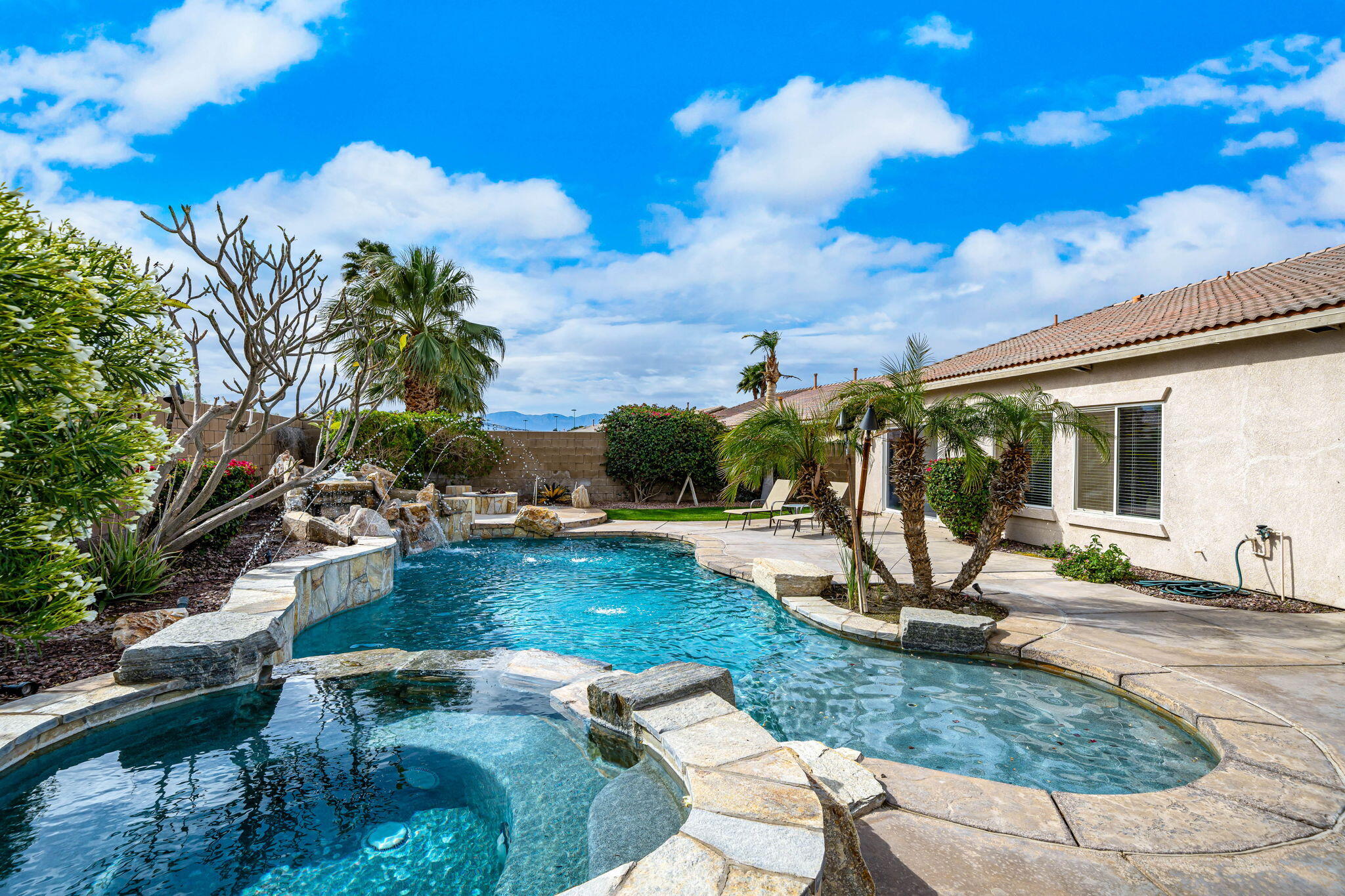 41222 Mackenzie Lane Indio, CA 92203 - Photo 23 of 27 a view of a swimming pool with a patio