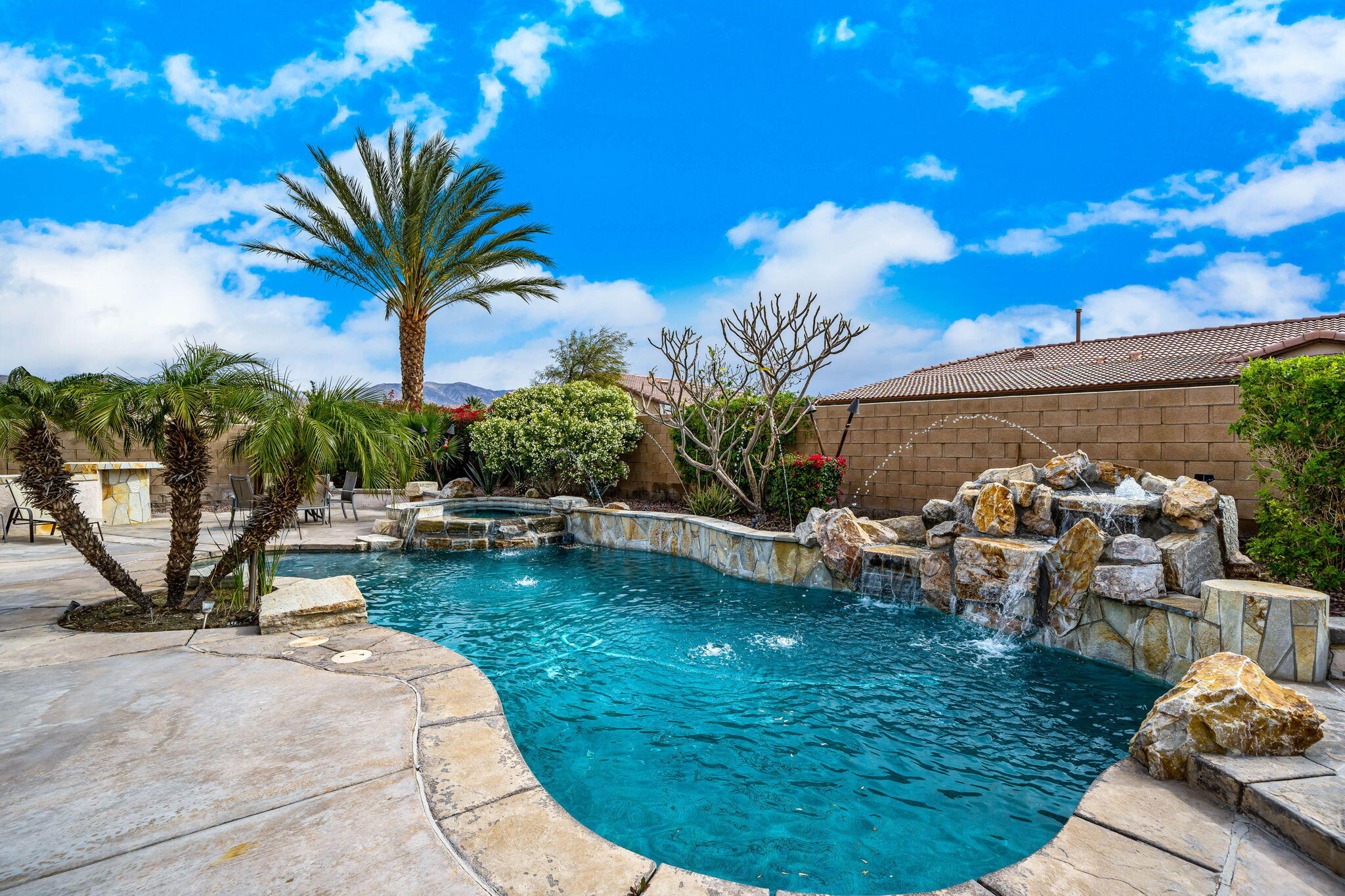 41222 Mackenzie Lane Indio, CA 92203 - Photo 24 of 27 a view of a swimming pool with a patio and a yard