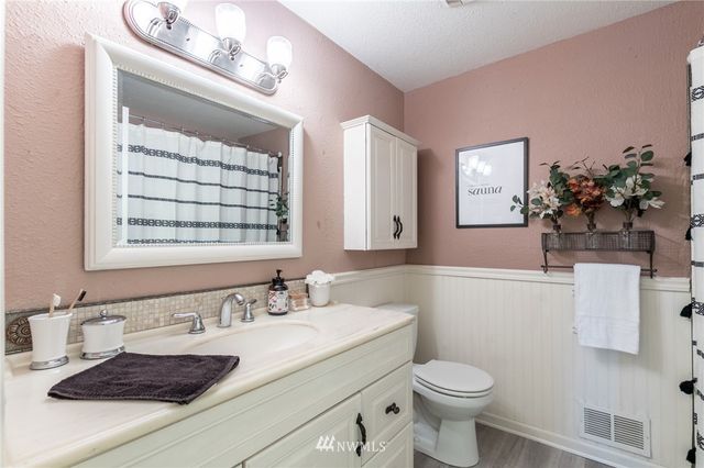 a bathroom with a sink toilet and mirror