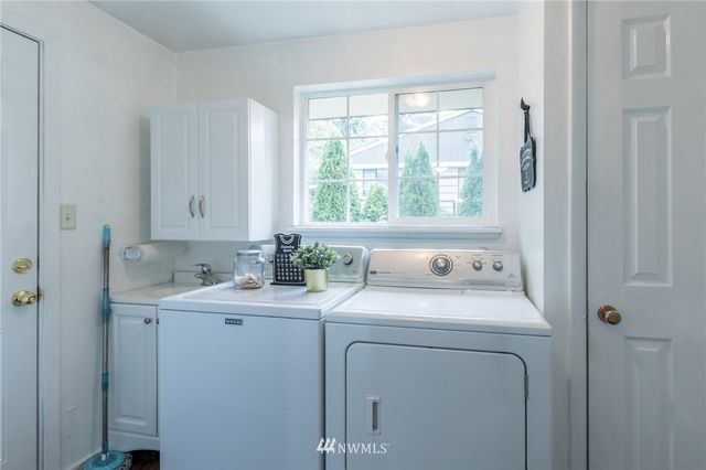 a utility room with closet dryer and washer