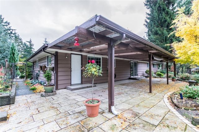 a view of a house with sitting area and garden