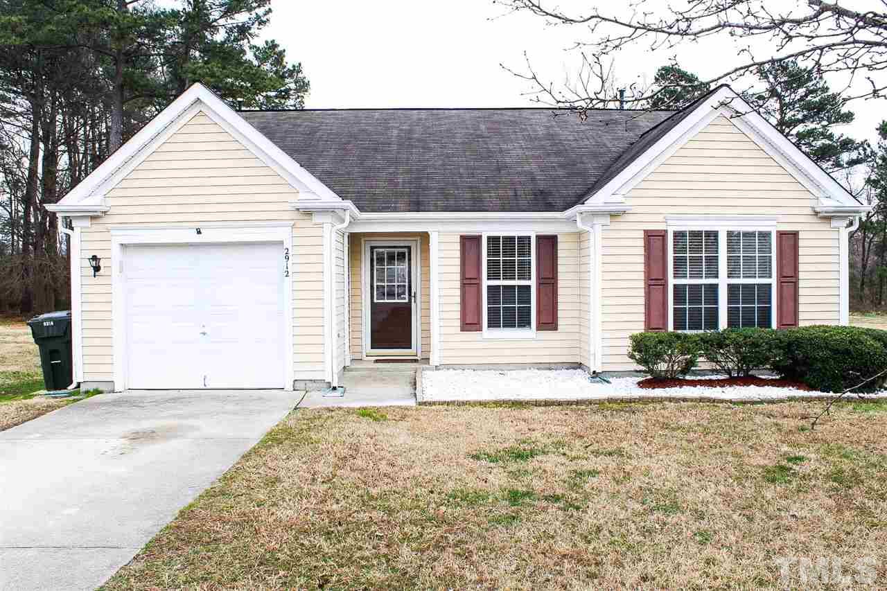 2912 Tuckland Drive Raleigh, NC 27610 - Photo 1 of 25 a view of yellow house with a yard