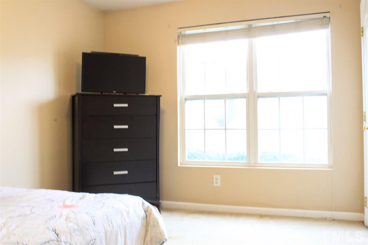 2912 Tuckland Drive Raleigh, NC 27610 - Photo 13 of 25 a bedroom with a bed and a window