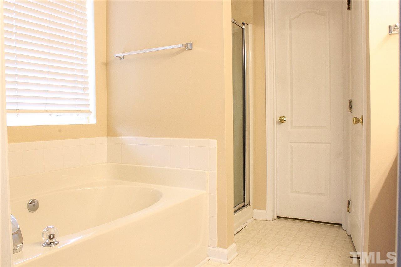 2912 Tuckland Drive Raleigh, NC 27610 - Photo 21 of 25 a bathroom with a bathtub and a shower
