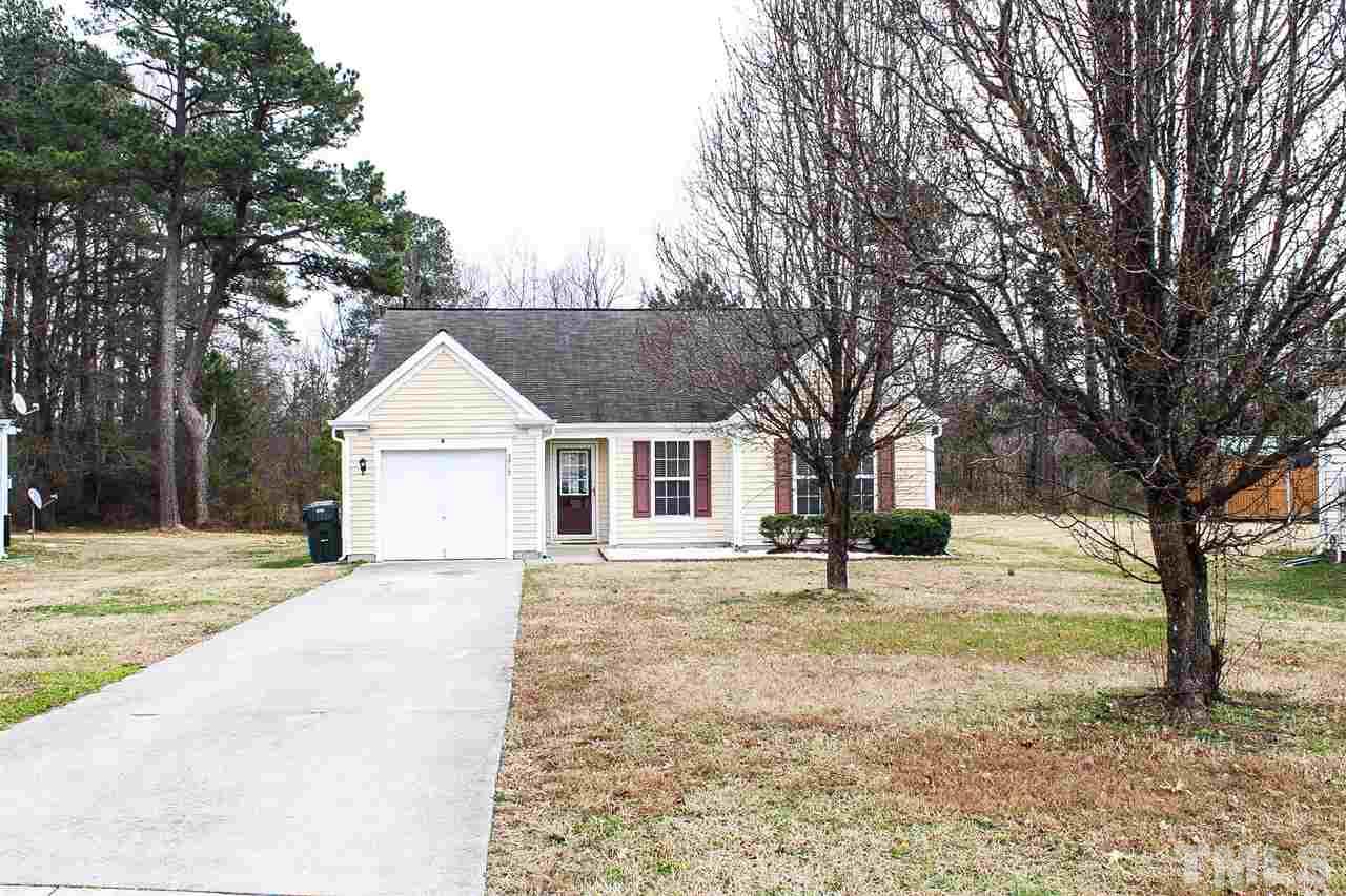 2912 Tuckland Drive Raleigh, NC 27610 - Photo 24 of 25 a house with trees in the background