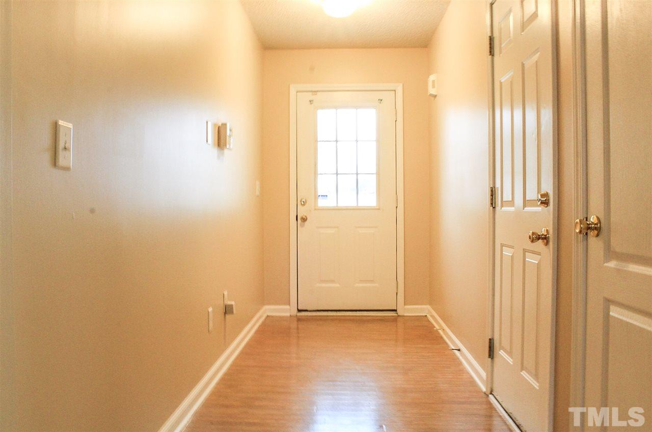 2912 Tuckland Drive Raleigh, NC 27610 - Photo 5 of 25 a view of a room with wooden floor and windows
