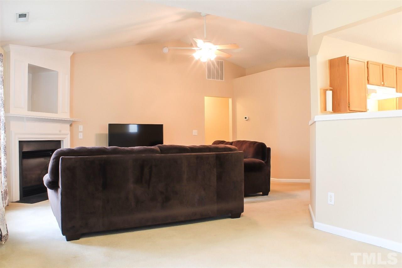 2912 Tuckland Drive Raleigh, NC 27610 - Photo 7 of 25 a living room with furniture and a fireplace