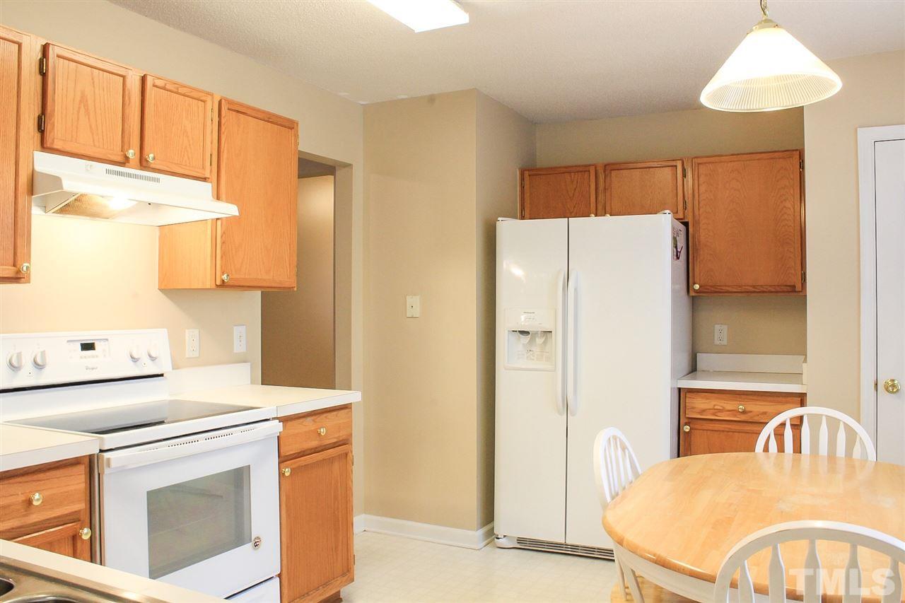 2912 Tuckland Drive Raleigh, NC 27610 - Photo 9 of 25 a kitchen with a refrigerator stove and a sink
