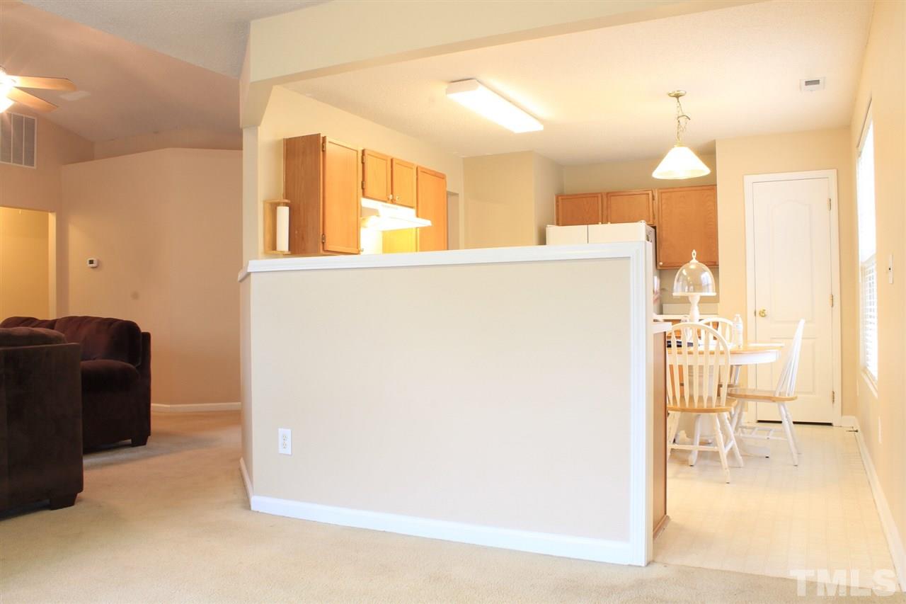 2912 Tuckland Drive Raleigh, NC 27610 - Photo 10 of 25 a view of a hallway with wooden floor and a living room