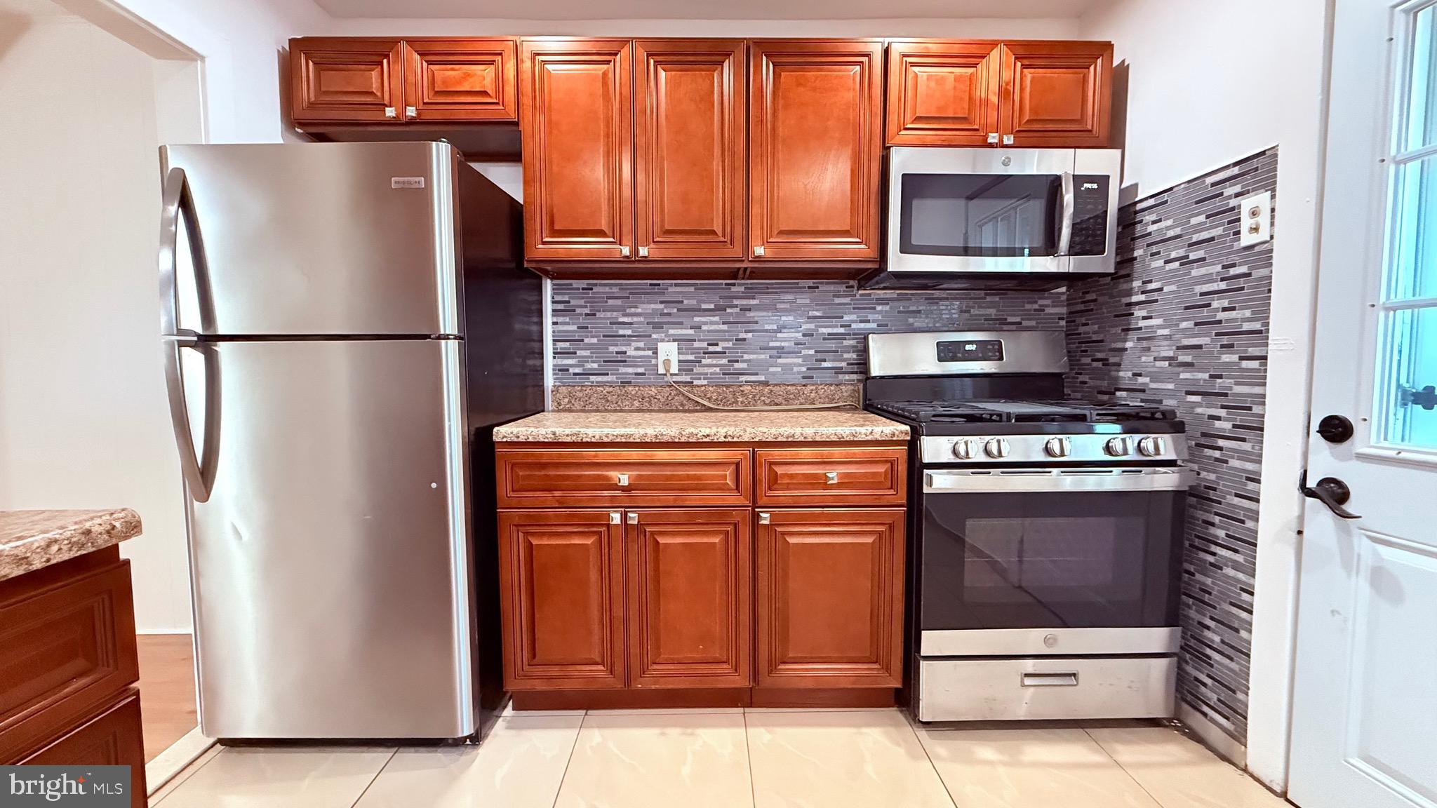 6424 Bingham Street Philadelphia, PA 19111 - Photo 11 of 32 a kitchen with appliances and cabinets