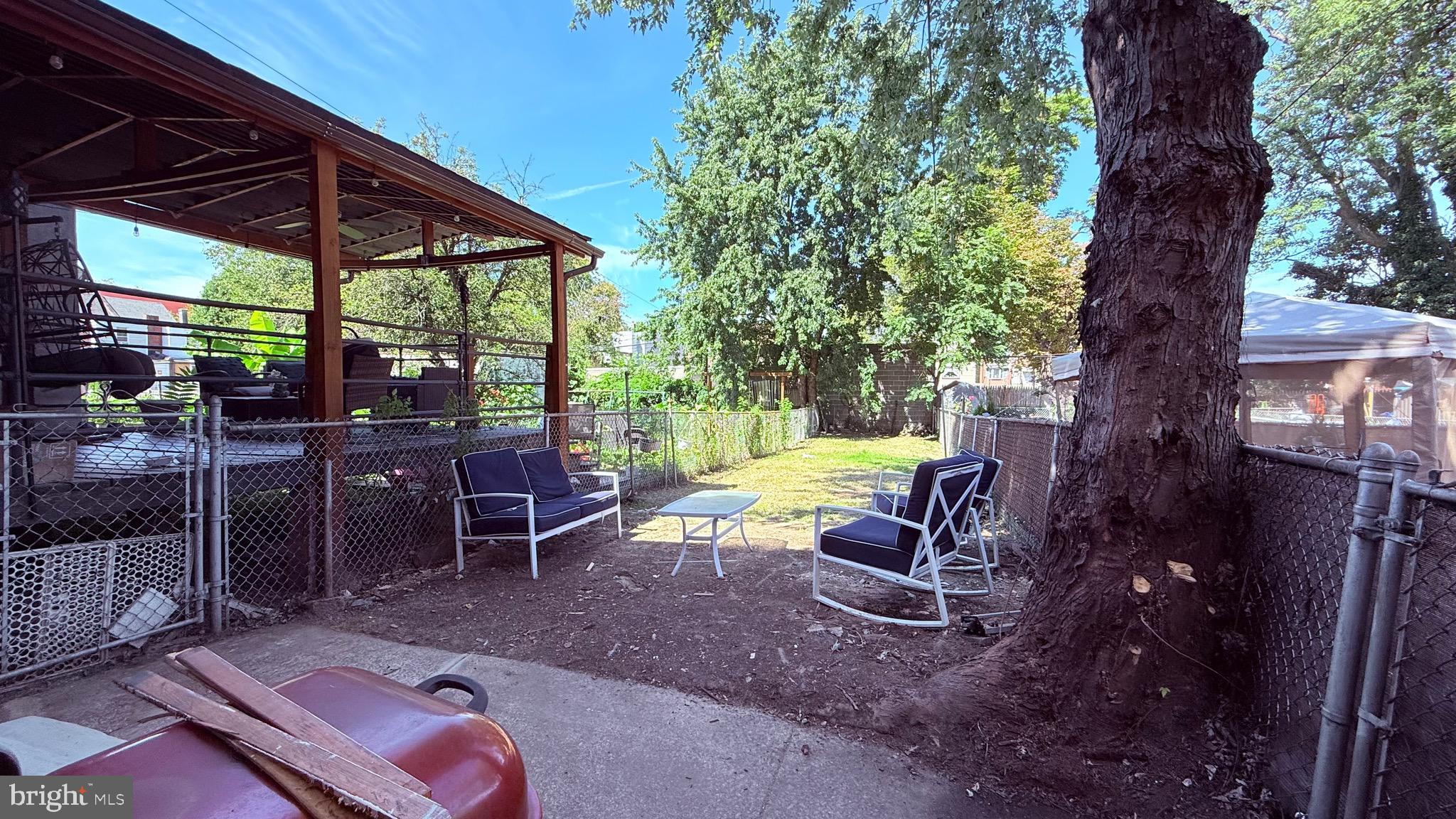 6424 Bingham Street Philadelphia, PA 19111 - Photo 14 of 32 a view of a patio with a table chairs and a backyard