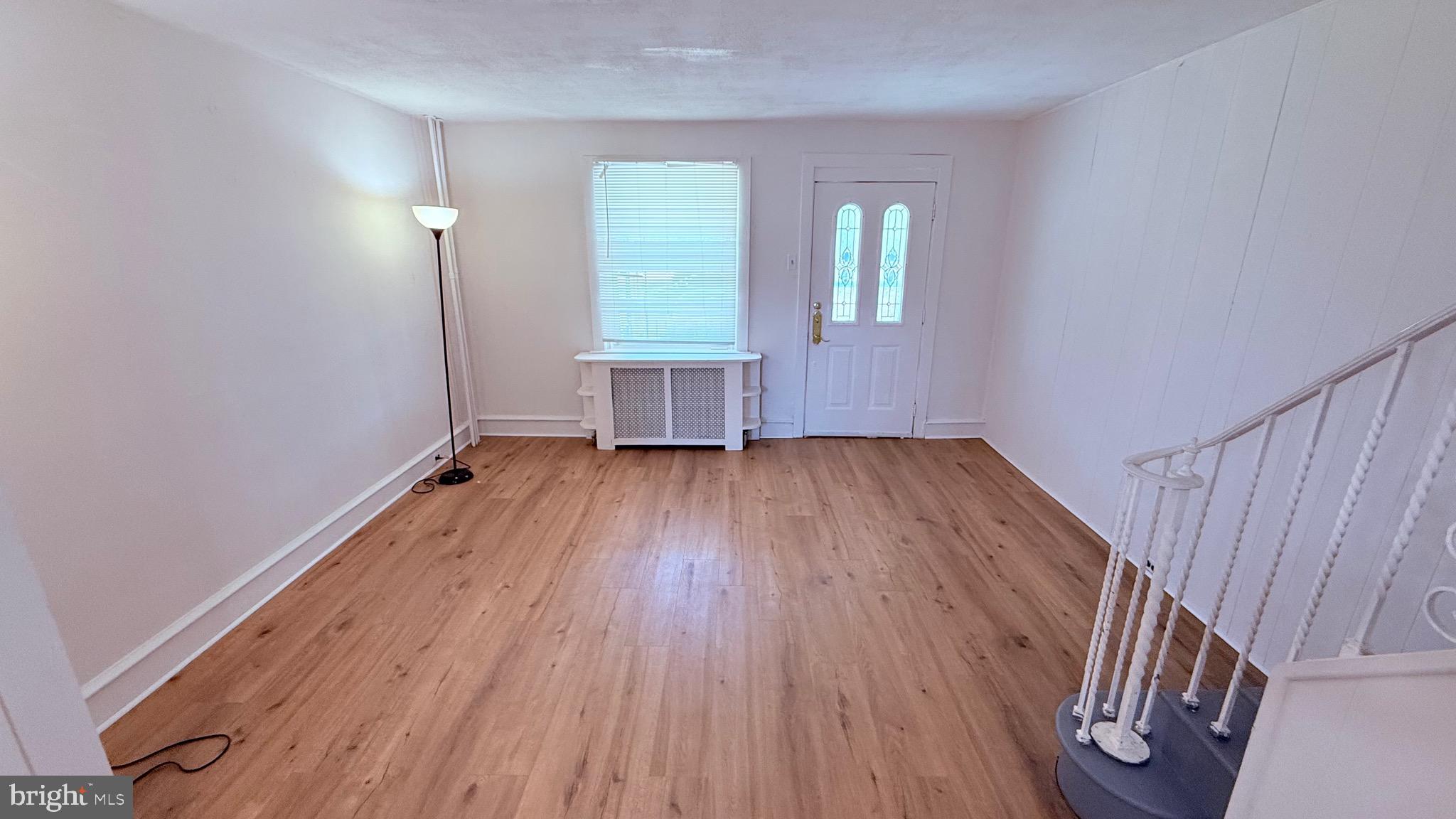 6424 Bingham Street Philadelphia, PA 19111 - Photo 6 of 32 an empty room with wooden floor and windows