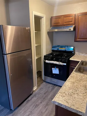 a kitchen with a refrigerator and a stove