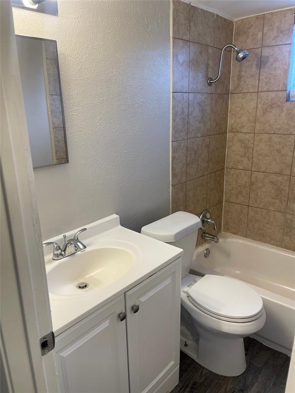 5526 Reiger Avenue, Unit 104 Dallas, TX 75214 - Photo 10 of 14 a bathroom with a sink a toilet and shower