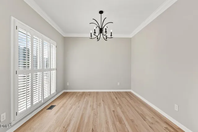 a view of a hallway with wooden floor and stairs