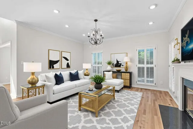 a view of a livingroom with a fireplace wooden floor and windows
