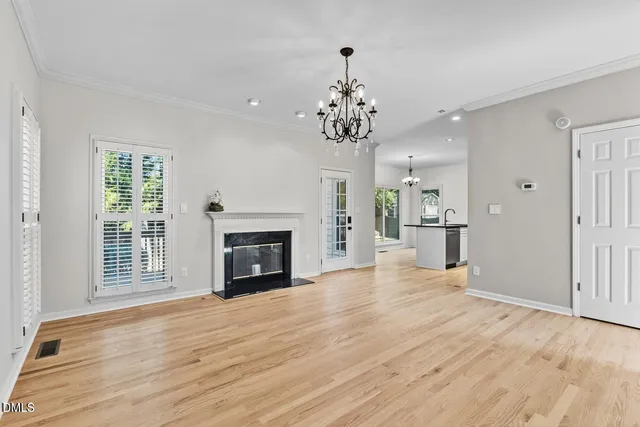 a kitchen with granite countertop a sink stainless steel appliances and white cabinets