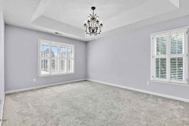 a spacious bedroom with a bed and a couch