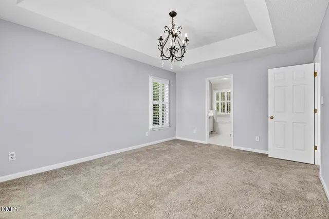 a spacious bathroom with a granite countertop sink mirror and bathtub