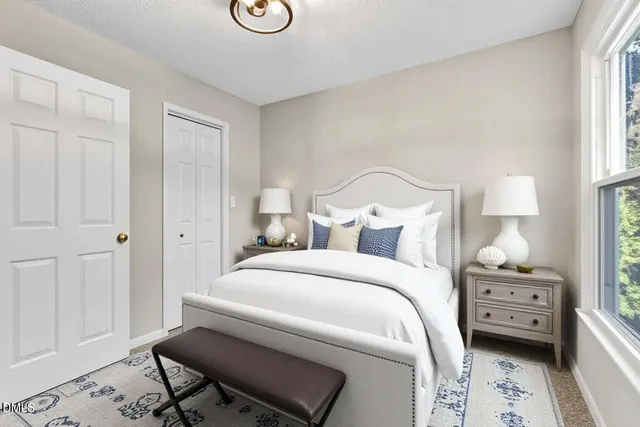 a spacious bedroom with a bed and large windows