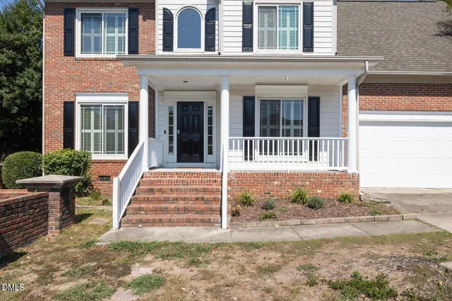 an aerial view of a house with garden space and sitting area