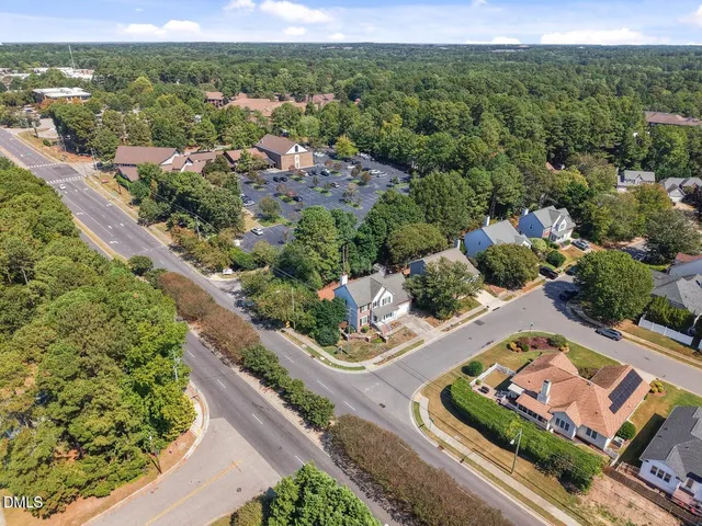 a view of staircase with lots of frames on wall and a window