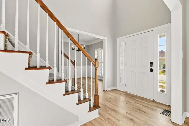 a living room with furniture flowers and a window