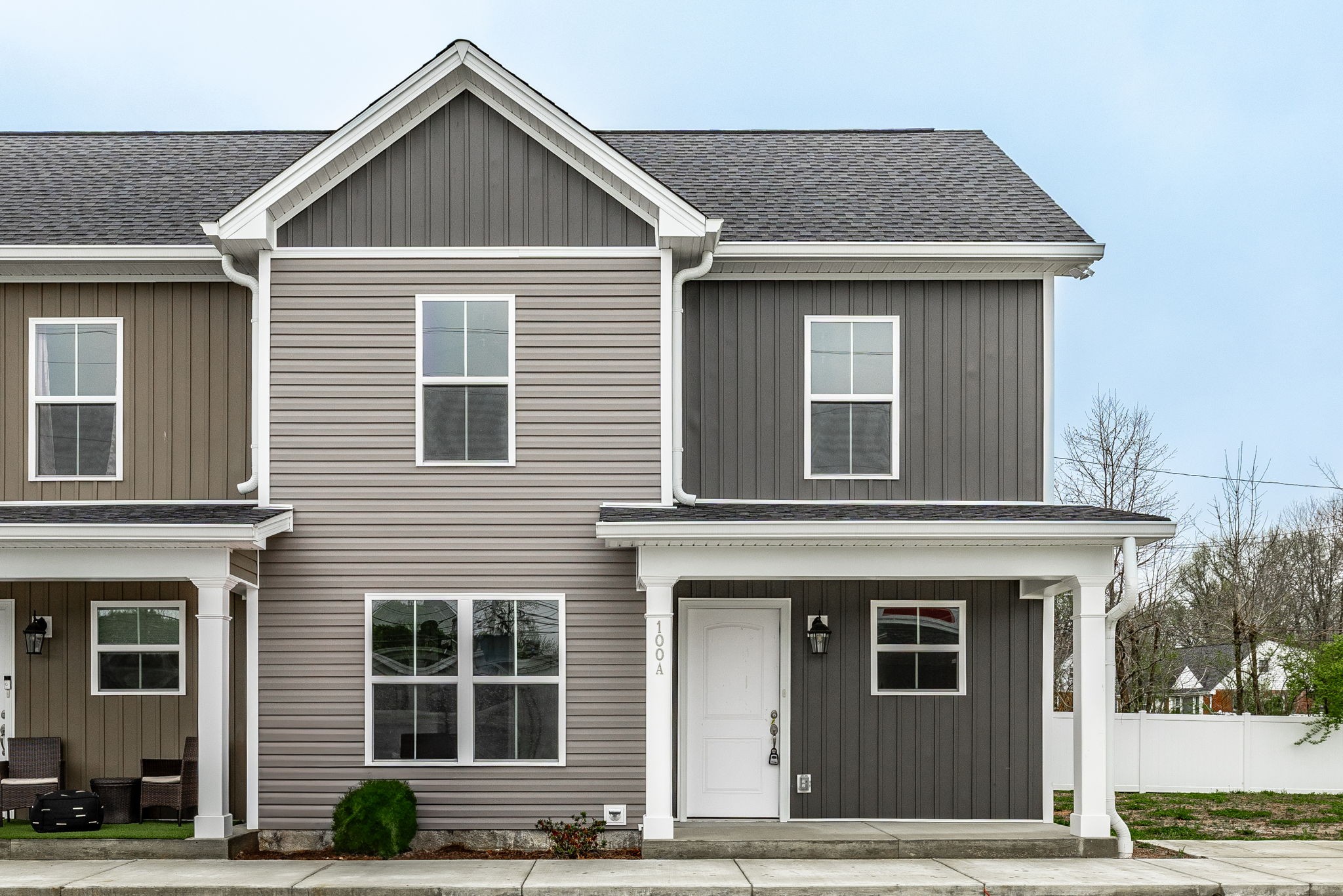 a view of a brick house with large windows