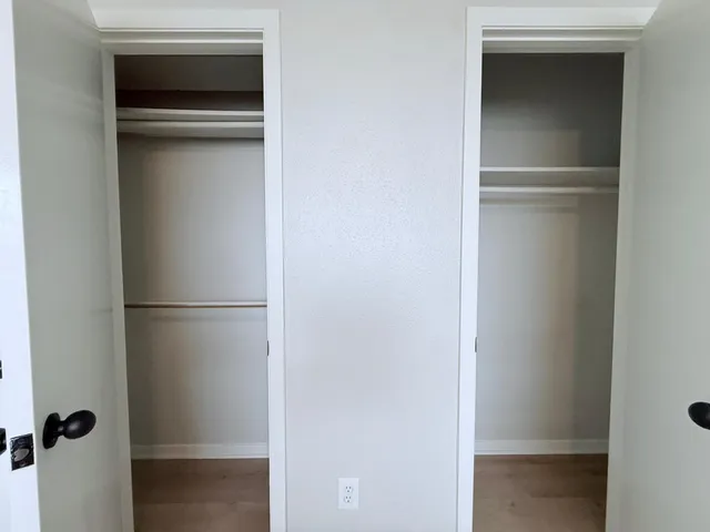 a view of walk in closet with empty racks