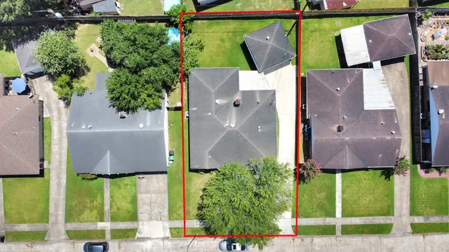 an aerial view of a house with a yard and plants