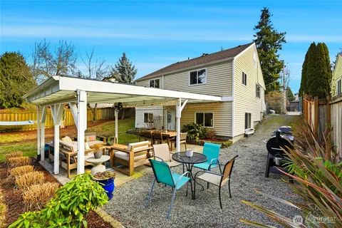 a view of a patio with table and chairs and potted plants